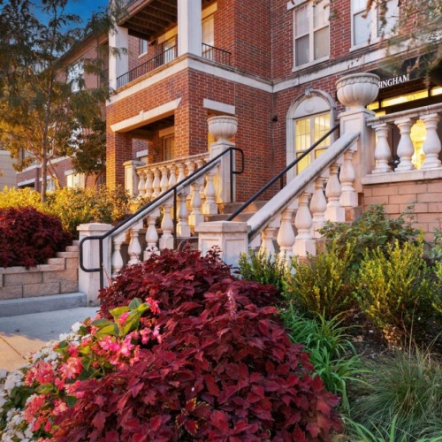 a building with a walkway and plants