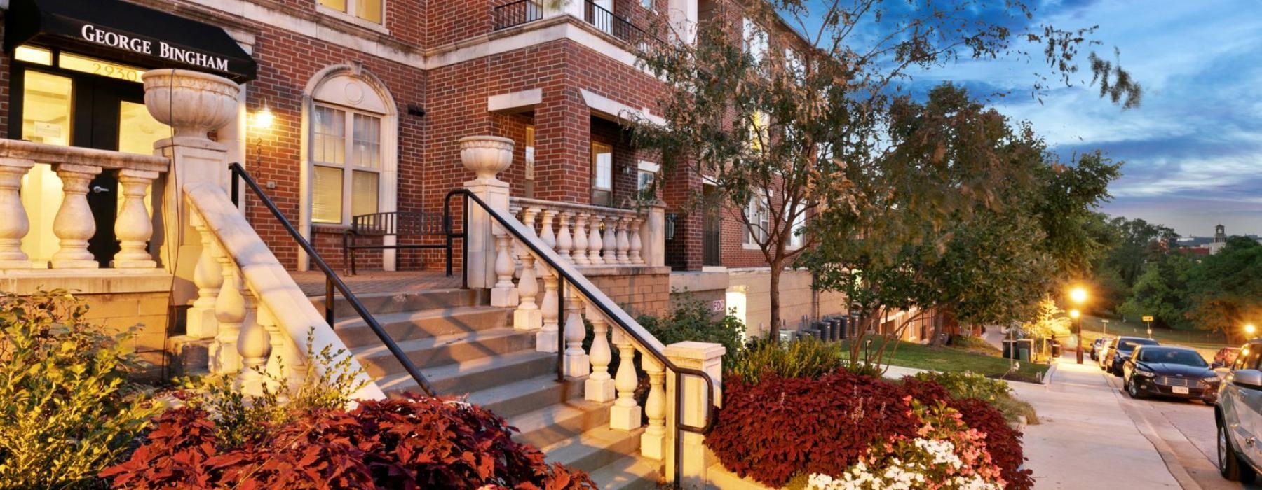 a building with a staircase and plants