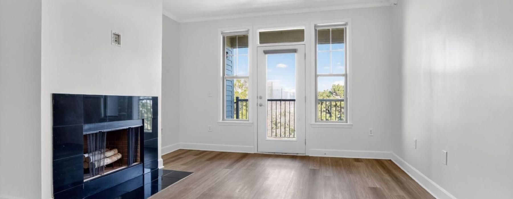 a room with a fireplace and windows